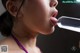 A woman sticking out her tongue with a bottle of water.