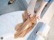 A woman's feet in a bathtub with a towel on the edge.