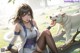A woman sitting on a tree branch next to a white dog.