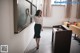 A woman standing in front of a blackboard in a classroom.